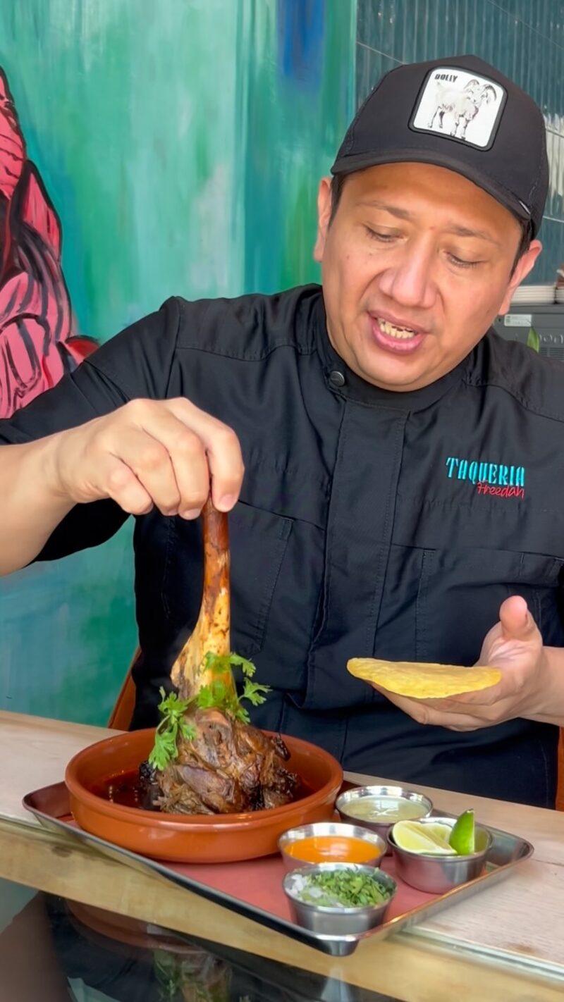 The chef plating slow-cooked beef with tortillas