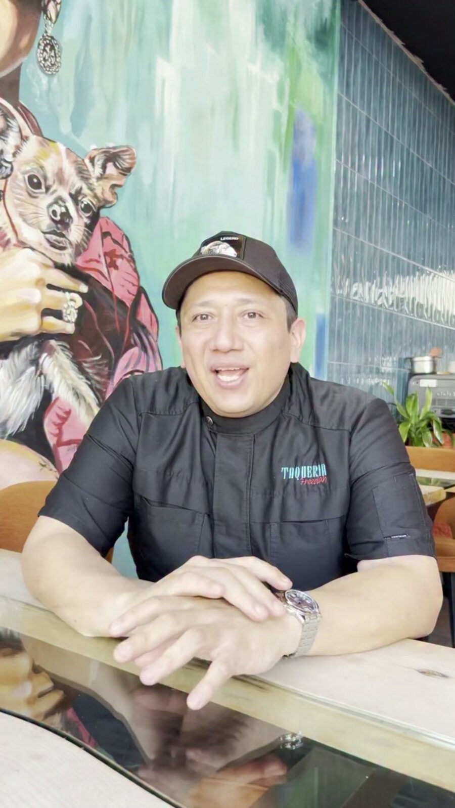 The chef in front of the chihuahua mural